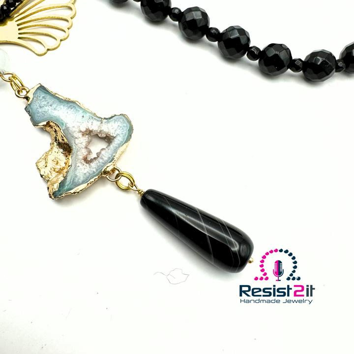 Collier Ocean Midnight détail du pendentif allongé et son élément ajouré doré.